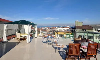 a balcony with chairs and tables on a building at Khalkedon Hotel Istanbul in Istanbul