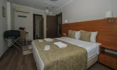 a hotel room with a bed with two towels on it at Belle Maison Hotel&Residence in Istanbul
