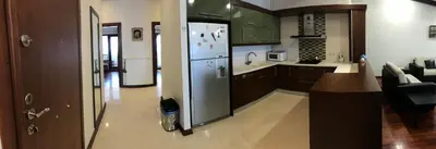 a kitchen with a stainless steel refrigerator and a living room at Belle Maison Hotel&Residence in Istanbul