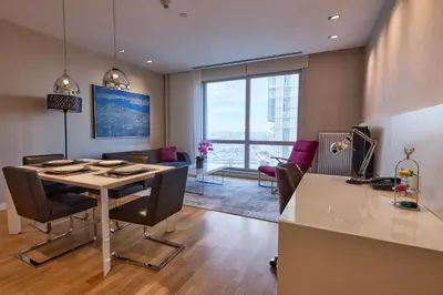 a kitchen and living room with a table and chairs at Fraser Place Anthill Istanbul in Istanbul