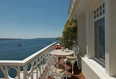 a balcony with a table and chairs and the water at The Stay Bosphorus in Istanbul