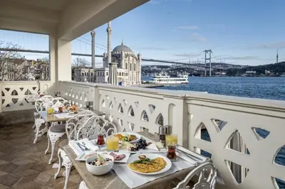 a table with food on a balcony with a view of the water at The Stay Bosphorus in Istanbul