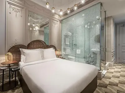 a bedroom with a large white bed and a window at The Stay Bosphorus in Istanbul