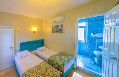 a bedroom with two beds and a bathroom at Ancient Town Hotel in Istanbul
