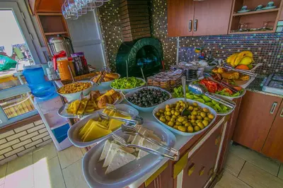 a kitchen counter with many bowls of fruits and vegetables at Ancient Town Hotel in Istanbul