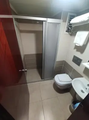 a bathroom with a shower and a toilet and a sink at Hotel Akyildiz in Istanbul