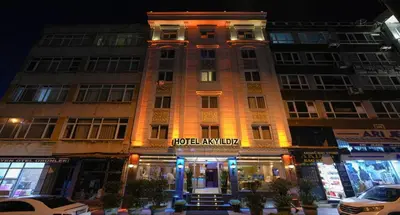 a tall building with a sign on it at night at Hotel Akyildiz in Istanbul