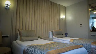a hotel room with two beds and a window at Kervansaray Bursa City Hotel in Bursa