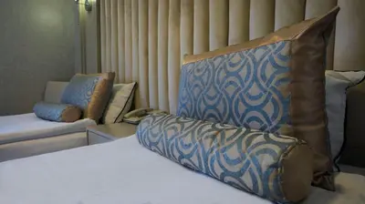 a bedroom with a bed and a couch and a chair at Kervansaray Bursa City Hotel in Bursa