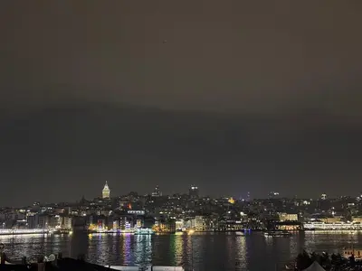 a view of a city at night with the water at Golden Horn Bosphorus Hotel in Istanbul