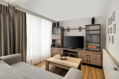a living room with a couch and a tv at Nardi Nişantaşı in Istanbul