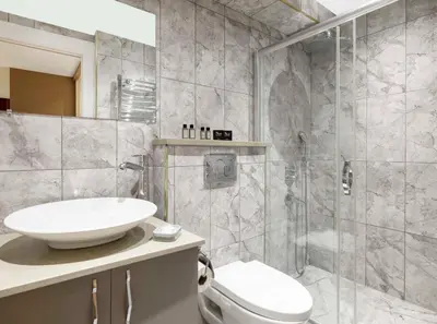 a bathroom with a toilet and a sink and a shower at Nardi Nişantaşı in Istanbul