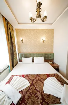 a hotel room with a bed and a chandelier at Sahil Boutique Hotel in Istanbul