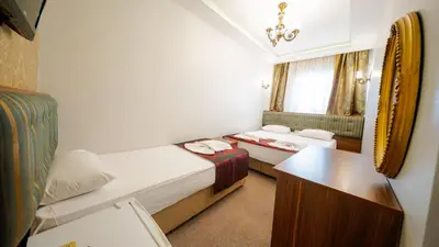 a small room with two beds and a table at Sahil Boutique Hotel in Istanbul