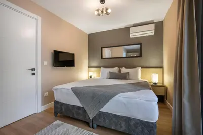 a bedroom with a large bed and a mirror at Çırağan Apart Bosphorus in Istanbul