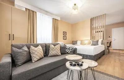 a living room with a couch and a bed at Çırağan Apart Bosphorus in Istanbul