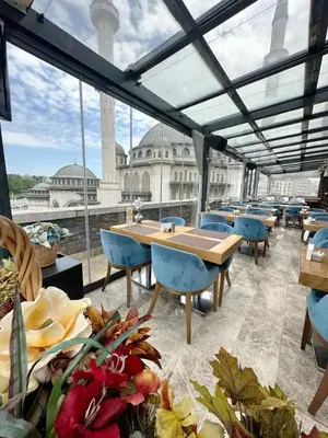 a restaurant with tables and chairs and a view of a building at Taksim Line Hotel in Istanbul