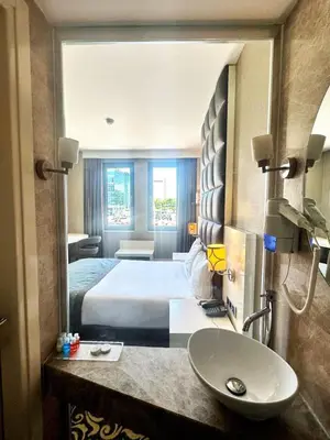 a hotel room with a bed and a sink at Taksim Line Hotel in Istanbul