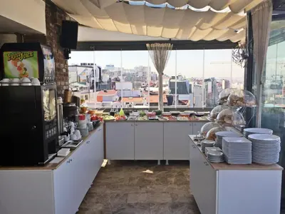 a large kitchen with a view of a city at Taksim Line Hotel in Istanbul