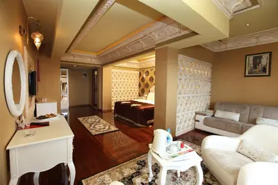 a living room with a couch and a bed at Deluxe Golden Horn Sultanahmet Hotel in Istanbul