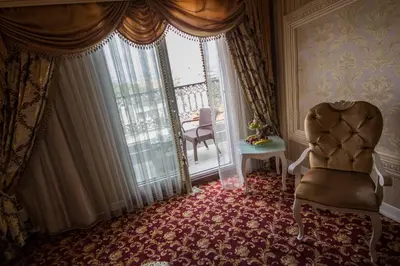 a room with a chair in front of a window at Deluxe Golden Horn Sultanahmet Hotel in Istanbul