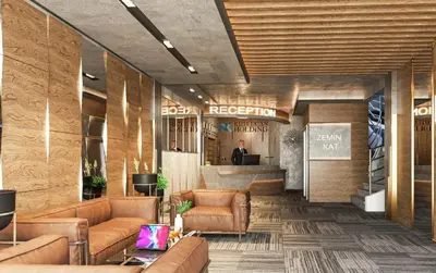 a lobby with brown leather furniture and a bar at Kutlucan Oldtown in Bursa