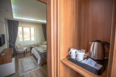 a room with a room with a bed and a tea kettle at Kutlucan Oldtown in Bursa