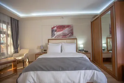 a hotel room with a bed and a mirror at Kutlucan Oldtown in Bursa