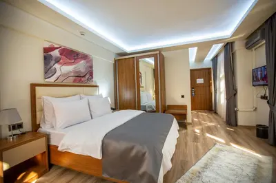 a bedroom with a large bed in a room at Kutlucan Oldtown in Bursa