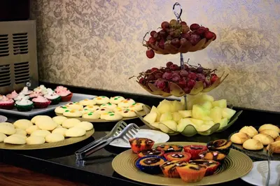a table topped with different types of food on plates at Burcman Hotel in Bursa