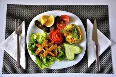 a plate of food with vegetables on a table at Elegance Resort Hotel & SPA Wellness-Aqua in Yalova