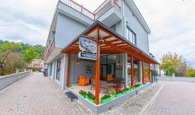 a building with a restaurant on a street at Room Room Motel in Sapanca