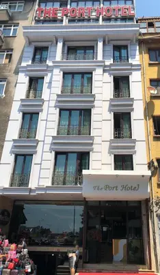 a white building with a sign on the front of it at The Port Hotel in Istanbul
