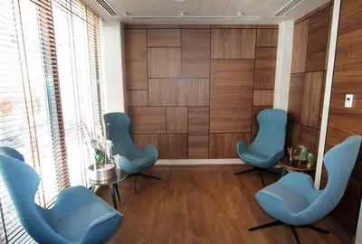 a waiting room with blue chairs and wooden walls at Mukarnas Taksim Hotel in Istanbul