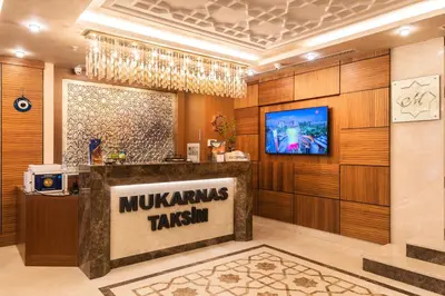 a lobby with a munchkins takesim sign on a counter at Mukarnas Taksim Hotel in Istanbul