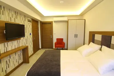 a hotel room with a bed and a television at RİVADA HOTEL in Kartepe