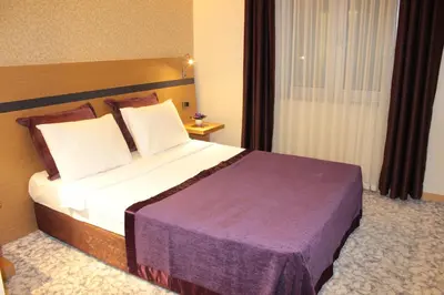 a bedroom with a large bed in a hotel room at Hotel Osaka Airport in Istanbul