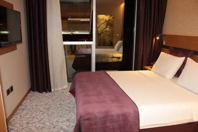 a hotel room with a large bed and a mirror at Hotel Osaka Airport in Istanbul