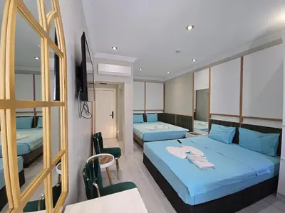 a hotel room with two beds and a mirror at The Empress Theodora Hotel ll in Istanbul