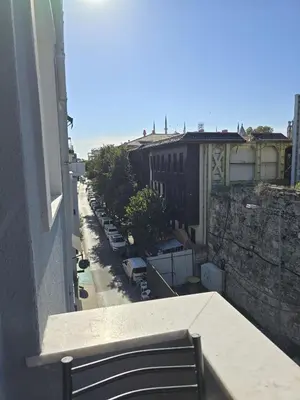 a view of a street from a balcony with a bench at The Empress Theodora Hotel ll in Istanbul