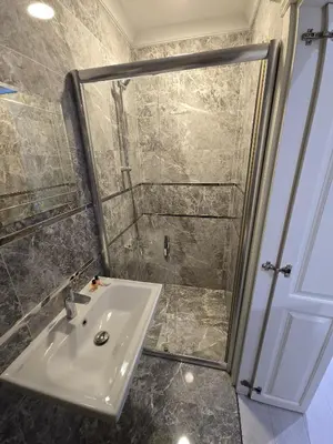 a bathroom with a sink and a shower at The Empress Theodora Hotel ll in Istanbul
