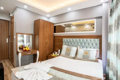 a bedroom with a large bed and a mirror at Istanbul Sirkeci Hotel in Istanbul