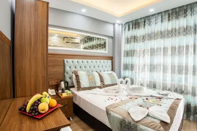 a bedroom with a bed with a tray of fruit on a table at Istanbul Sirkeci Hotel in Istanbul