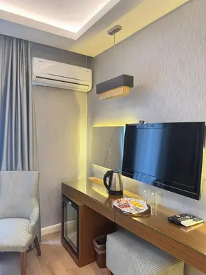 a hotel room with a large flat screen tv at Style Star Hotel Cihangir in Istanbul