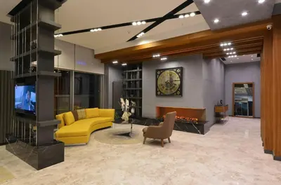 a living room with a yellow couch and a tv at Nish Palace Exlusive Suites in Istanbul