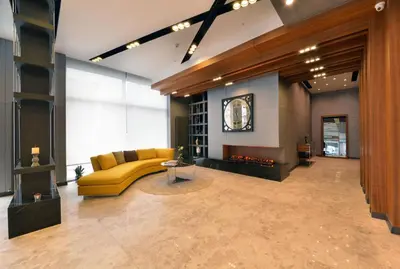 a living room with a yellow couch and a fireplace at Nish Palace Exlusive Suites in Istanbul