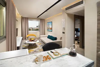 a hotel suite with a living room and a kitchen at Nish Palace Exlusive Suites in Istanbul