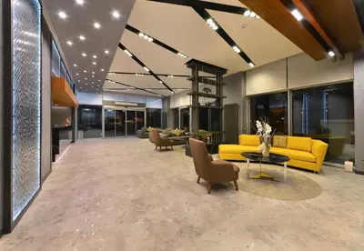 a lobby with a yellow couch and chairs and a table at Nish Palace Exlusive Suites in Istanbul