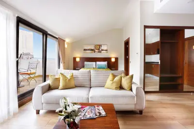 a living room with a couch and a bed at The White Orient Hotel in Istanbul
