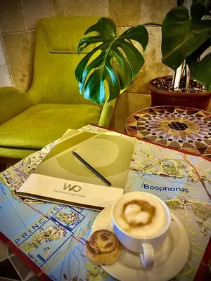 a cup of coffee and a pastry on a table at The White Orient Hotel in Istanbul